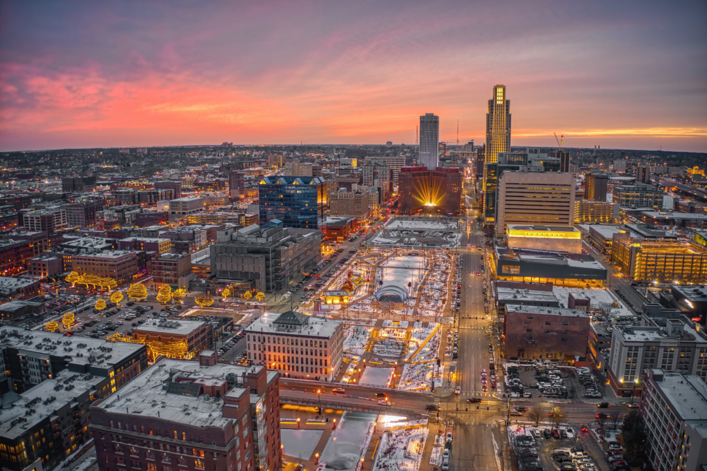 A panoramic view of Omaha's skyline with a focus on various business buildings, some with visible fencing.